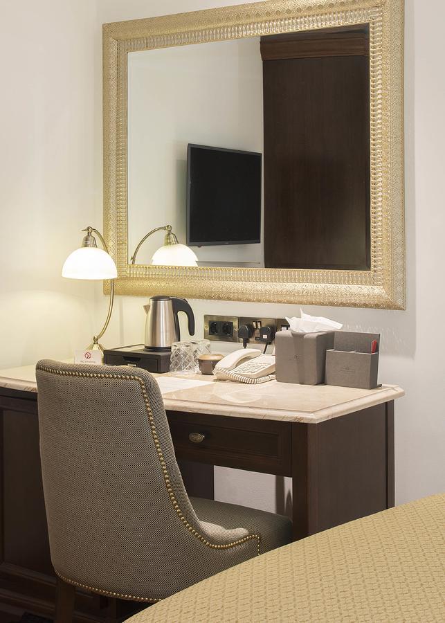 The George Street Hotel Oxford Exterior photo A hotel room desk with a telephone, a kettle, and a television